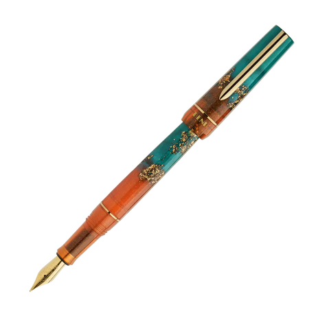 BENU presents the newest Haute Collection — a line of elegant, fashion-inspired pens that blend classic charm with bold, modern flair. The designs include both subtle and vibrant styles, showcasing BENU’s signature glitter and color artistry. Each pen features a faceted body with alternating wide and slender facets, complemented by either gold-plated or chrome-plated trims for a sleek, timeless look.

With a bold orange and teal body streaked with gold, Chic turns heads with runway-ready style. Fashion-forw