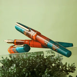 BENU presents the newest Haute Collection — a line of elegant, fashion-inspired pens that blend classic charm with bold, modern flair. The designs include both subtle and vibrant styles, showcasing BENU’s signature glitter and color artistry. Each pen features a faceted body with alternating wide and slender facets, complemented by either gold-plated or chrome-plated trims for a sleek, timeless look.

With a bold orange and teal body streaked with gold, Chic turns heads with runway-ready style. Fashion-forw