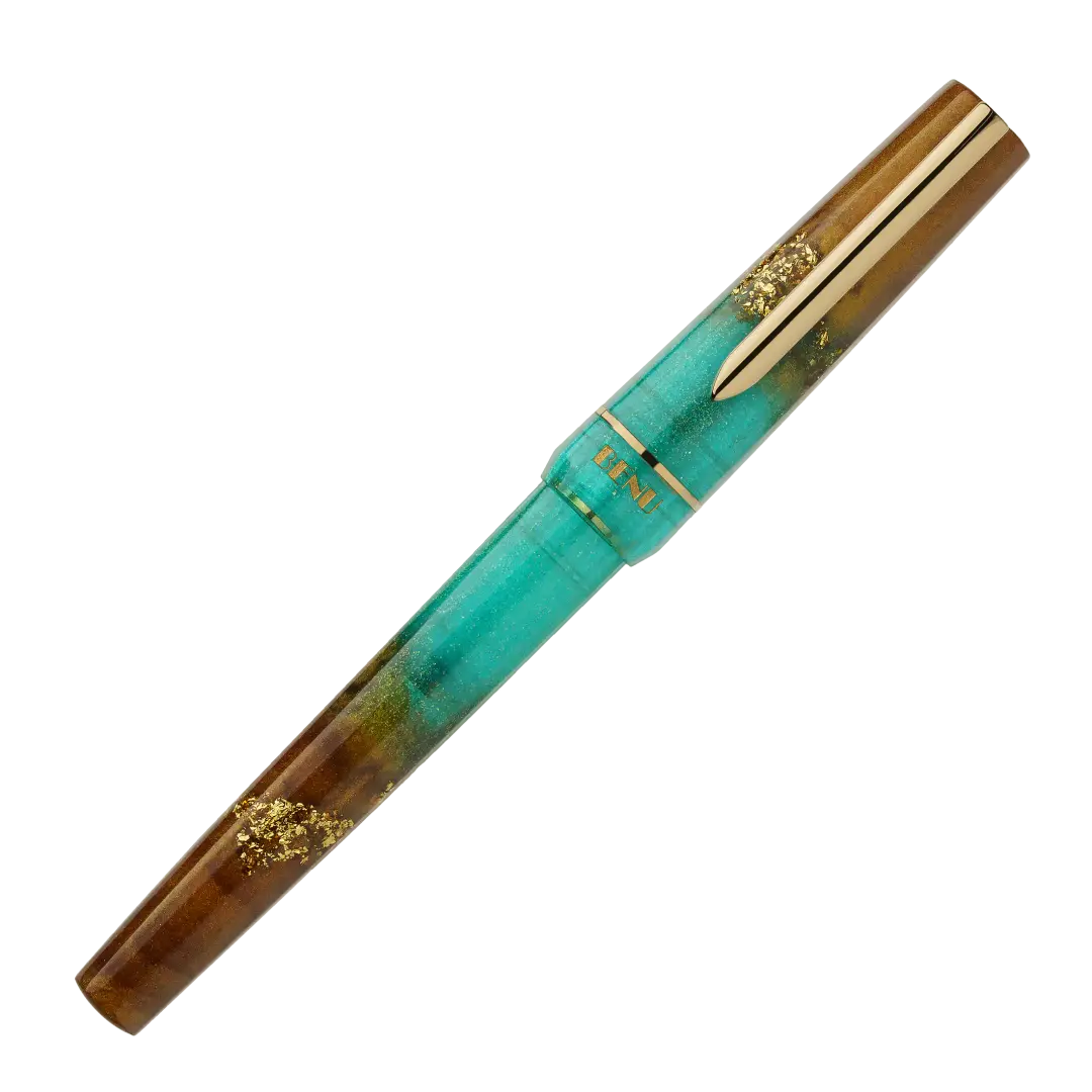 BENU presents the newest Haute Collection — a line of elegant, fashion-inspired pens that blend classic charm with bold, modern flair. The designs include both subtle and vibrant styles, showcasing BENU’s signature glitter and color artistry. Each pen features a faceted body with alternating wide and slender facets, complemented by either gold-plated or chrome-plated trims for a sleek, timeless look.

Seal and caramel tones swirl together, flecked with radiant gold. Lush evokes runway opulence — bold, textu