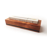Put your favorite Blackwing 12-pack on display. This mahogany, solid wood pencil display is designed to showcase a single 12-pack Blackwing pencil box in a flat-lay position. Its clean, premium, and minimalist profile fits perfectly on every desk, shelf, or wall using the predrilled mounting holes. The Blackwing logo is engraved on the side.

The Blackwing Flat Box display measures 9.8125 x 3.25 x 1.75 inches.