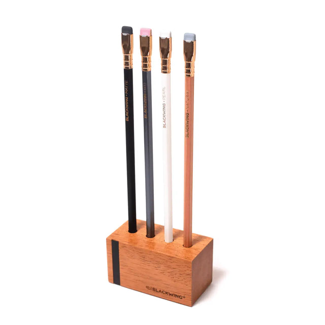 This solid wood pencil display is made with mahogany and is designed to showcase four upright Blackwing pencils. Display the four core Blackwing pencils, or choose four of your favorite designs to add some character to your desk. This display fits well on a desk or shelf, or you can hang it using the predrilled mounting holes. Blackwing logo engraved on the side.

The Blackwing Upright Four Pencil display measures 3.5 x 1.75 x 1.875 inches.