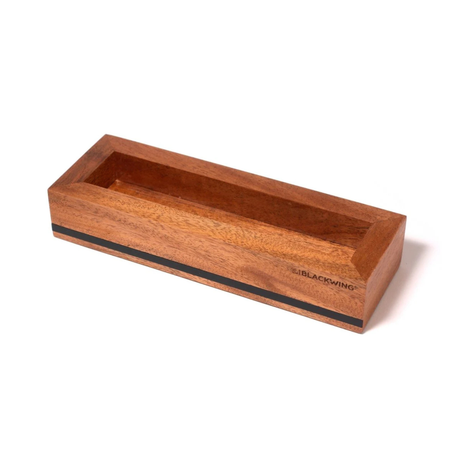 Put your favorite Blackwing 12-pack on display. This mahogany, solid wood pencil display is designed to showcase a single 12-pack Blackwing pencil box in a flat-lay position. Its clean, premium, and minimalist profile fits perfectly on every desk, shelf, or wall using the predrilled mounting holes. The Blackwing logo is engraved on the side.

The Blackwing Flat Box display measures 9.8125 x 3.25 x 1.75 inches.