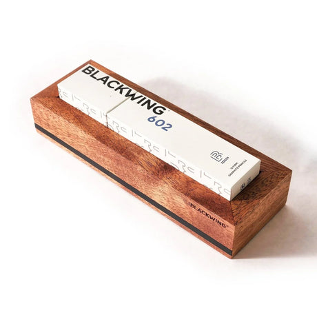 Put your favorite Blackwing 12-pack on display. This mahogany, solid wood pencil display is designed to showcase a single 12-pack Blackwing pencil box in a flat-lay position. Its clean, premium, and minimalist profile fits perfectly on every desk, shelf, or wall using the predrilled mounting holes. The Blackwing logo is engraved on the side.

The Blackwing Flat Box display measures 9.8125 x 3.25 x 1.75 inches.
