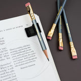 The Blackwing Notebook Clip is designed to keep your pencil and paper together. The clip is made of aluminum and finished with our signature matte black texture. Once you attach the reusable clip to your notebook, your pencil snaps into a durable thermoplastic polymer that won't scuff the lacquer. Perfect for everyday carry—clip it onto your spiral notebook, legal pad, memo book, or reading book to keep your stationery organized.