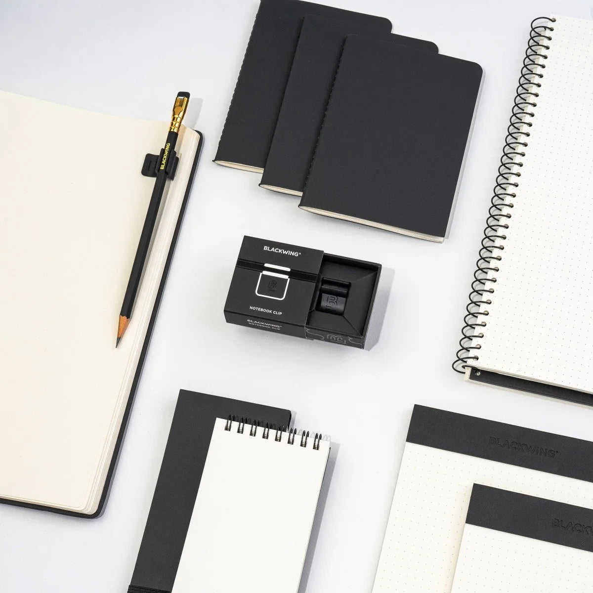 The Blackwing Notebook Clip is designed to keep your pencil and paper together. The clip is made of aluminum and finished with our signature matte black texture. Once you attach the reusable clip to your notebook, your pencil snaps into a durable thermoplastic polymer that won't scuff the lacquer. Perfect for everyday carry—clip it onto your spiral notebook, legal pad, memo book, or reading book to keep your stationery organized.