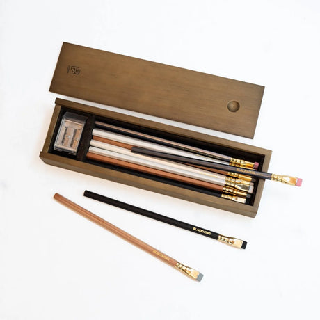 The Blackwing Rustic Box features your choice of 12 premium Blackwing graphite pencils and our reliable Two-Step Long Point Sharpener. Choose from 12 Matte pencils,12 602 pencils, 12 Pearl pencils, 12 Natural pencils, or 3 of each. The aged pine pencil box slides open to reveal the Blackwing pencils and a black cork-lined interior. The smooth stationery box is perfect for any workspace, office, or desk.