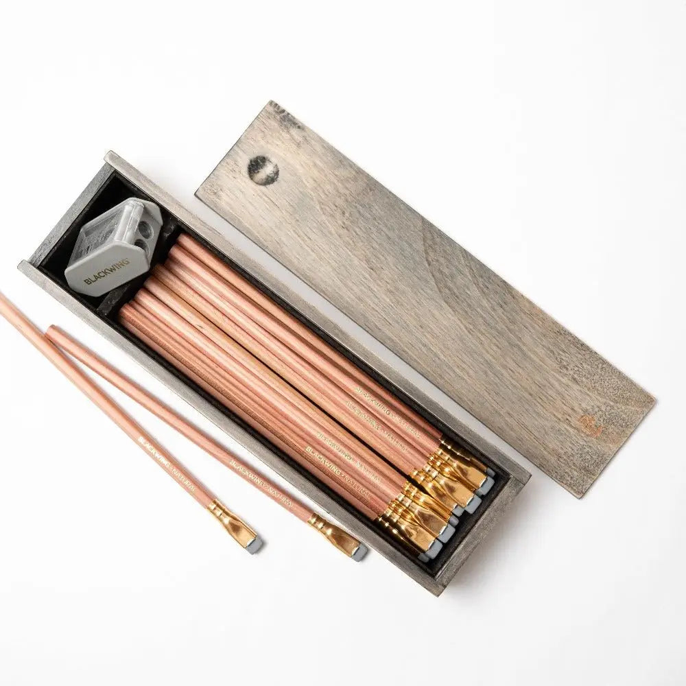Blackwing Rustic Box Set - Natural

The Blackwing Rustic Box features your choice of 12 premium Blackwing graphite pencils and our reliable Two-Step Long Point Sharpener. Choose from 12 Matte pencils,12 602 pencils, 12 Pearl pencils, 12 Natural pencils, or 3 of each. The aged pine pencil box slides open to reveal the Blackwing pencils and a black cork-lined interior. The smooth stationery box is perfect for any workspace, office, or desk.

All Rustic Boxes now come with our Grey Two-Step Long Point Sharpene
