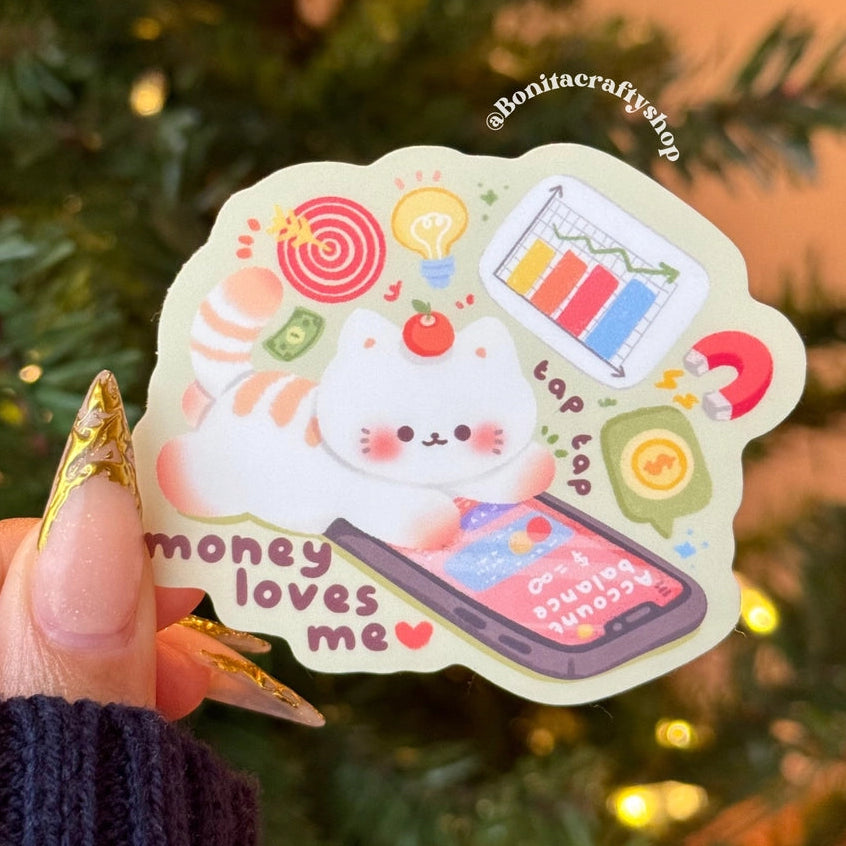 Manifest abundance with this adorable “Money Loves Me” matte sticker 💖💰 Featuring a cute kawaii character surrounded by finance icons, charts, savings, and money vibes. ✨

♡ STICKER DETAILS ♡
~ Sticker size: 2.9’’ inches
~ Printed on matte sticker paper
~ Matte Laminate finish ✨
~ ONLY Handwash. This sticker is not dishwasher or microwave safe.