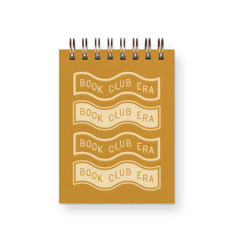 Step into your book club era with our delightful mini notebook, featuring a captivating wavy design and the phrase "Book Club Era" on the cover. Perfect for book lovers and note-takers alike, this notebook is designed to inspire and accompany you through every literary journey.

Additional Details : 
-3”x4"
-65 Unlined Interior Pages
-Uncoated Vellum 70# Text Off-White Interior Paper 
-Bronze Wire-O Binding
-Locally Made in Lawrence, Kansas
-Packaged in a clear cello sleeve
