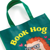 Oink-redibly cute and practical! Our Book Hog Reusable Shopping Bag is the perfect piggy companion for your shopping adventures. This adorable book-loving hog design turns errands into fun while helping you ditch single-use bags. Sturdy enough for groceries, books, or beach essentials, it folds up small when not in use. Shop sustainably with this playful porker that's always ready to carry your treasures!