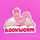 The bookworm is a truly unique creature. This cute little worm spends its days burrowing through the pages of many books and with its tiny glasses it wiggles its way through the literary landscape, reading tales of adventure, love, and knowledge. It immerses itself in the tapestry of stories, traveling through realms of imagination and finds joy in the depths of literature. Celebrate reading with this cute little wormie if that sounds like you too! Design features a hand drawn worm reading a book with the w