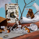 Dumpster chic meets unapologetic attitude in the Trash Bandits Sticker Book—a gloriously messy collection of oversized stickers featuring raccoons, possums, pigeons, and other urban icons with googly eyes and snarky commentary. Whether you're decorating your planner or marking your territory, these critters are here to add some trashy charm to your everyday life.

Inside, you’ll find 18 pages of trash animal stickers + 2 bonus pages of vintage-inspired puffy stickers, all packed with clever quips and chaoti