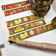 A washi tape inspired by plants and bookish things! This is a reprint of an older design - the colors are a little brighter this time. Each roll of washi tape is 15mm (approximately 0.59 inches) wide and 10 meters (approximately 10.9 yards) long.

Washi tapes have a small labeling sticker with branding and design, but without extra packaging.