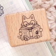 A small wood stamp of a little literary kitty for your planner and scrapbooking needs. Each stamp measures approximately 1 x 0.75 inch.

Stamps come loose and without any extra packaging.