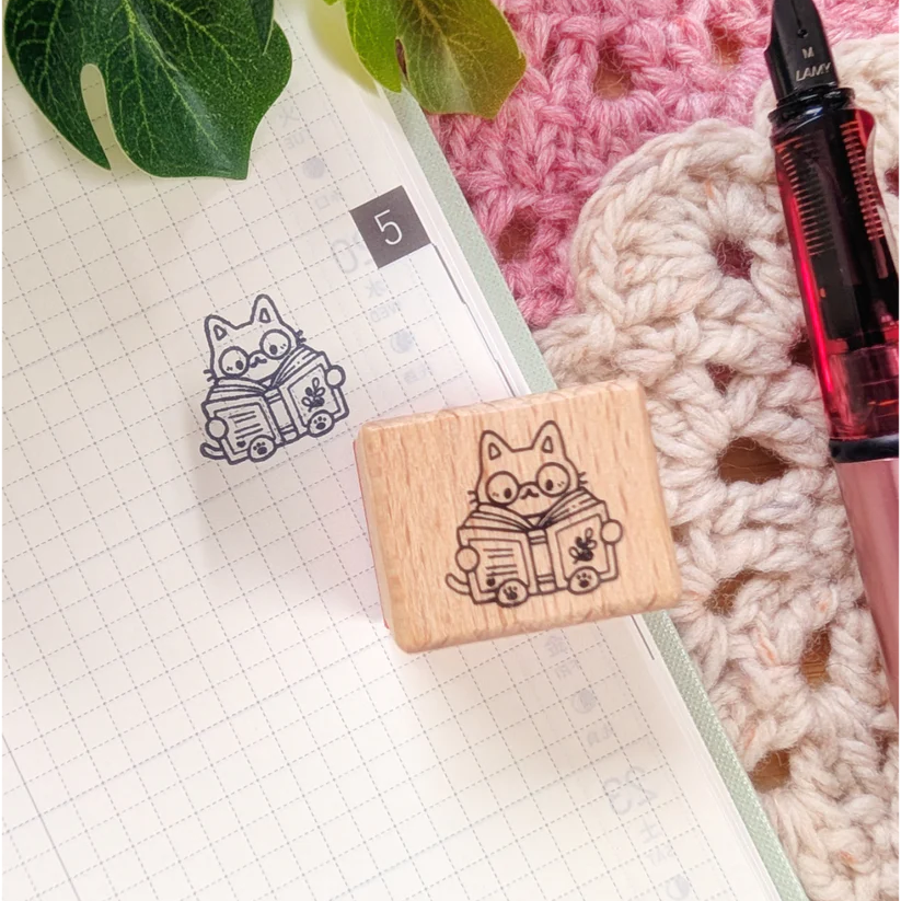 A small wood stamp of a little literary kitty for your planner and scrapbooking needs. Each stamp measures approximately 1 x 0.75 inch.

Stamps come loose and without any extra packaging.