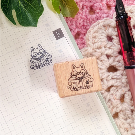 A small wood stamp of a little literary kitty for your planner and scrapbooking needs. Each stamp measures approximately 1 x 0.75 inch.

Stamps come loose and without any extra packaging.