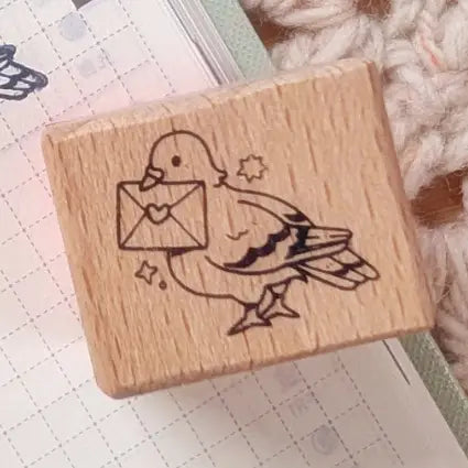 A small wood stamp of a little pigeon delivering your mail for your planner and scrapbooking needs. Each stamp measures approximately 1 x 0.75 inch.

Stamps come loose and without any extra packaging.