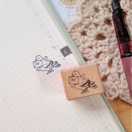 A small wood stamp of a little pigeon delivering your mail for your planner and scrapbooking needs. Each stamp measures approximately 1 x 0.75 inch.

Stamps come loose and without any extra packaging.