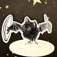 An adorable vinyl sticker of a brave bat with a sword and a shield, ready to be the protector of the world!

Includes 1 vinyl sticker
Dimensions: 3in x 2.5in
Dishwasher Safe and Water resistant
Perfect for water bottles, laptops, folders and more!