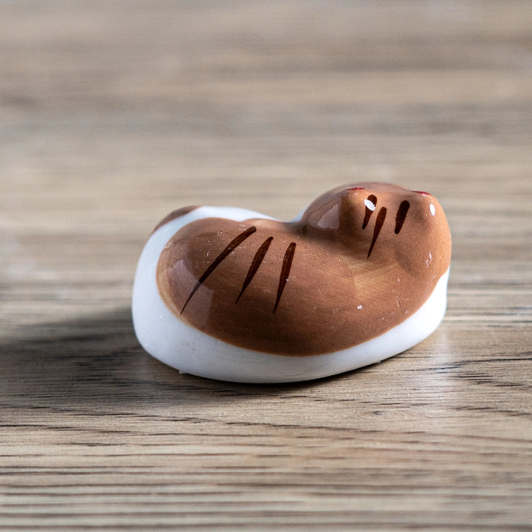 Porcelain brown cat chopstick rest / pen rest.