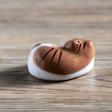 Porcelain brown cat chopstick rest / pen rest.