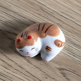 Porcelain brown cat chopstick rest / pen rest.