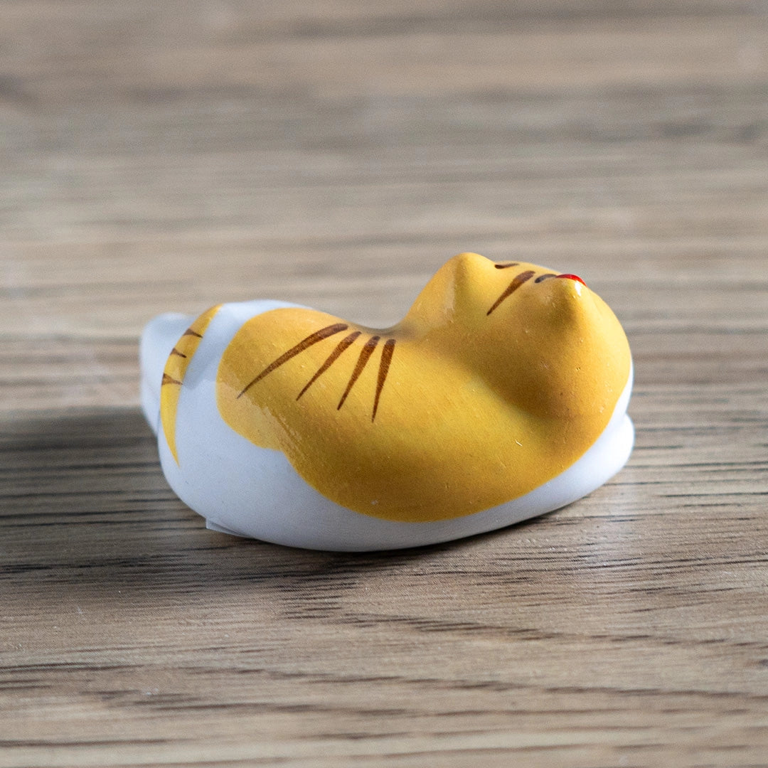 Porcelain yellow cat chopstick rest / pen rest.