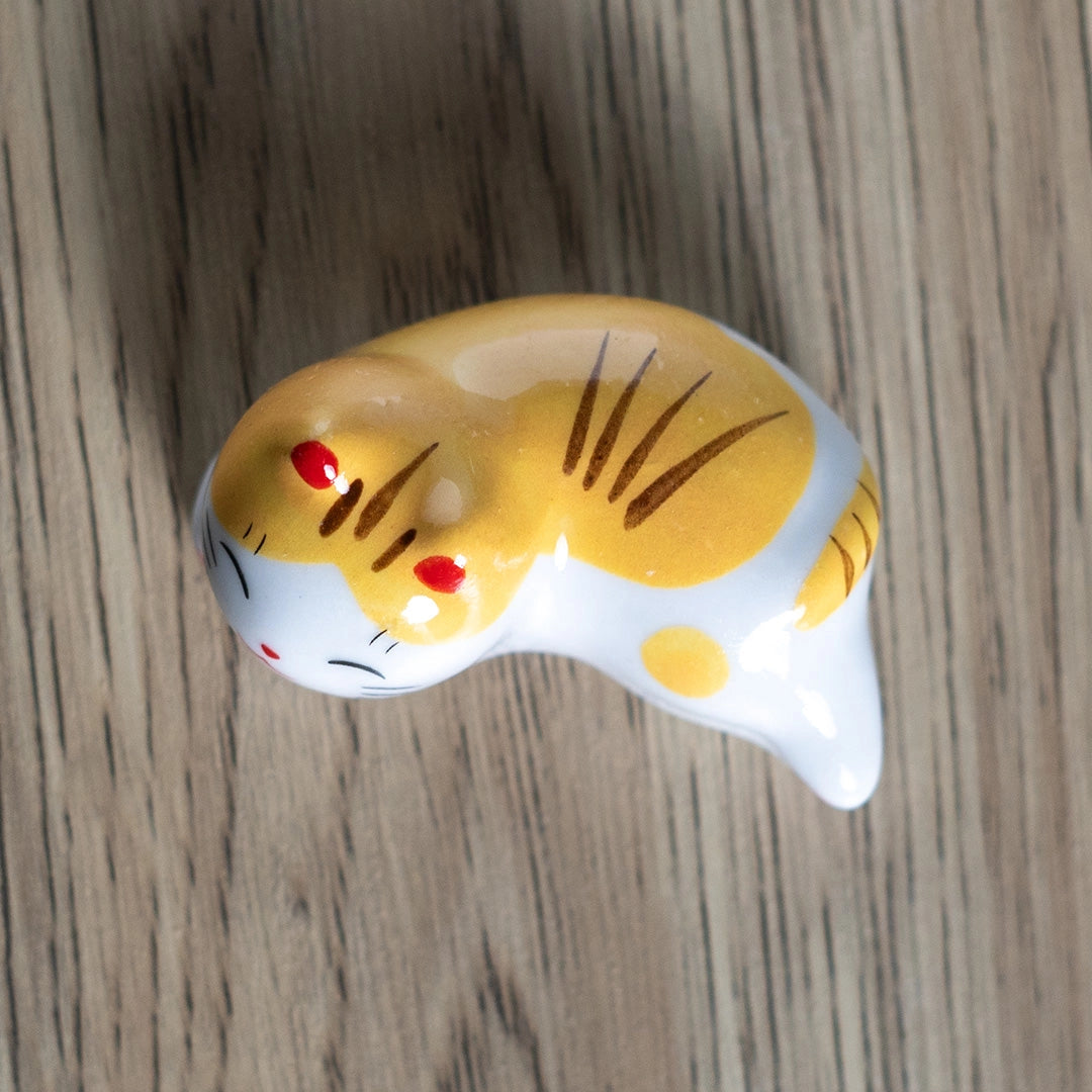 Porcelain yellow cat chopstick rest / pen rest.