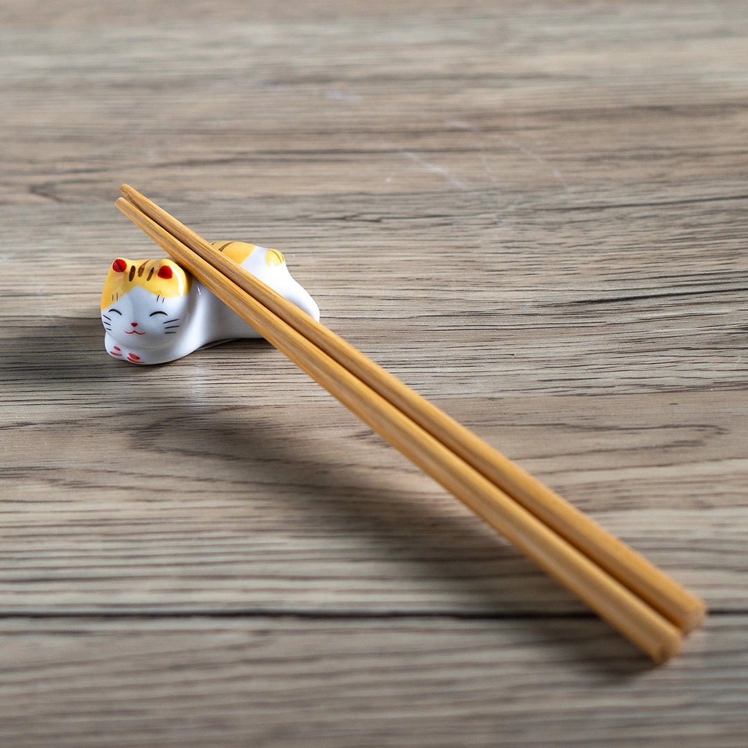 Porcelain yellow cat chopstick rest / pen rest.