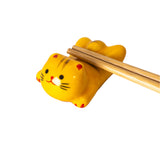 Porcelain yellow cat chopstick rest / pen rest.