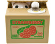 Cat hiding in strawberry box coin bank.

Size: 4.75"L x 4"W x 3.75"H

Material: Plastic