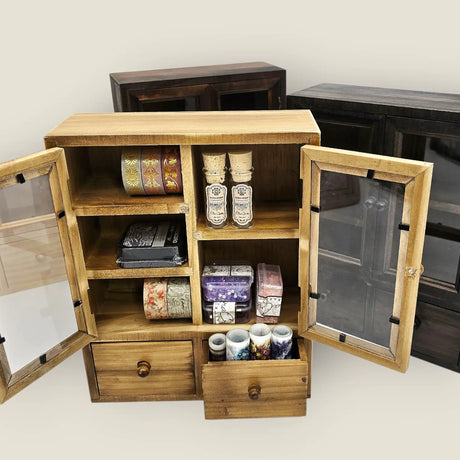 These wooden cabinets will add a beautiful decorative touch to your desk or creative space. They are also highly functional, with two drawers, and shelves of different heights. This product is handmade and an exclusive design of CoraCreaCrafts.

Important Note: This product includes the wooden cabinet only. Any decorative items on the inside are for display purposes only.

Size: 20 x 25 x 7.5cm