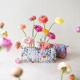 Each versatile pouch showcases premium quilted cotton in four distinct illustrated patterns, complemented by an elegant gold brass zipper with coordinating pull—adding a sophisticated finishing touch to these signature pieces.

Features:

Size: 7" x 3" x 2"
Premium quilted cotton exterior
Coordinating interior cotton lining
Gold brass zipper with matching pull
Versatile use as pencil pouch or makeup bag
Perfect for desk display or on-the-go organization