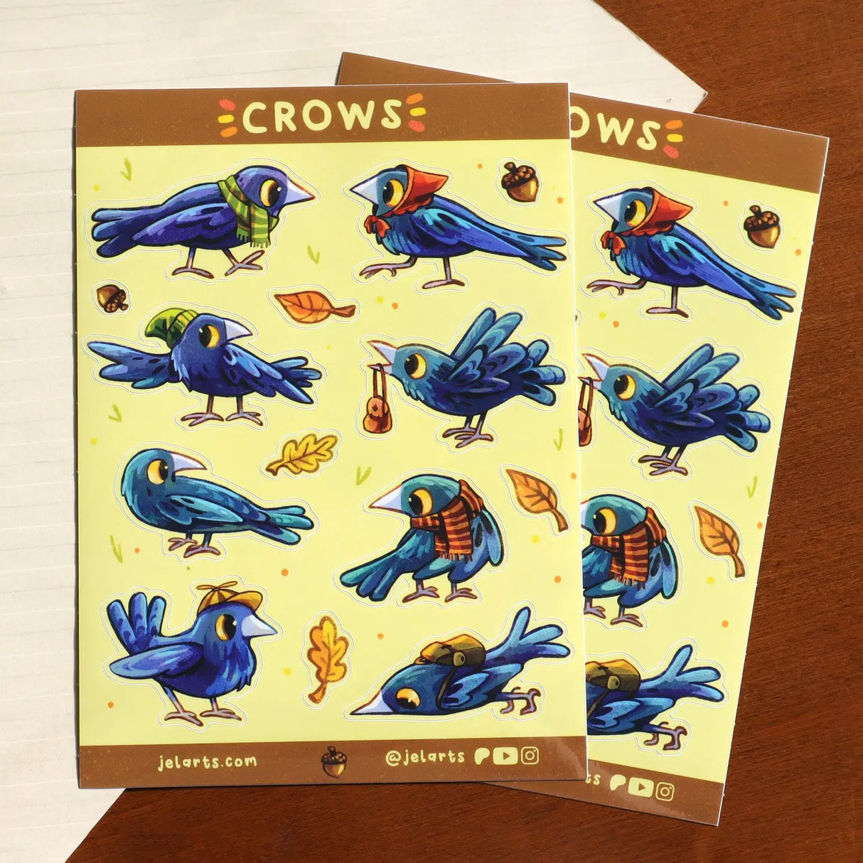 A bunch of crows with various accessories. Some backpacks, scarves and hats! 8 Total large stickers, and 6 smaller stickers.

Waterproof vinyl sticker sheet, 5"x7"
14 peelable stickers per sheet
Durable and high quality
Packaged in a clear plastic sleeve