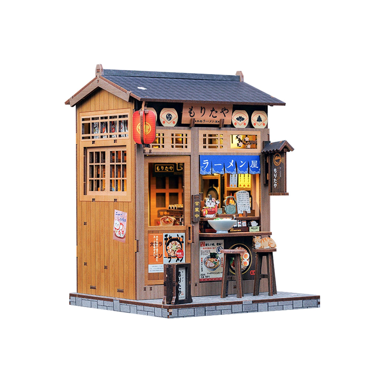 From the iconic noren curtain swaying above the window to the finely detailed counter lined with ramen bowls, rice balls, and sake bottles, every element of the Ramen Sake House DIY book nook kit captures the warm, nostalgic spirit of a cozy late-night eatery tucked away in a quiet Tokyo alley. Soft LED lights bathe the scene in a gentle glow, evoking the hum of conversation, the clink of dishes, and the comforting aroma of a midnight meal.