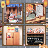 From the iconic noren curtain swaying above the window to the finely detailed counter lined with ramen bowls, rice balls, and sake bottles, every element of the Ramen Sake House DIY book nook kit captures the warm, nostalgic spirit of a cozy late-night eatery tucked away in a quiet Tokyo alley. Soft LED lights bathe the scene in a gentle glow, evoking the hum of conversation, the clink of dishes, and the comforting aroma of a midnight meal.
