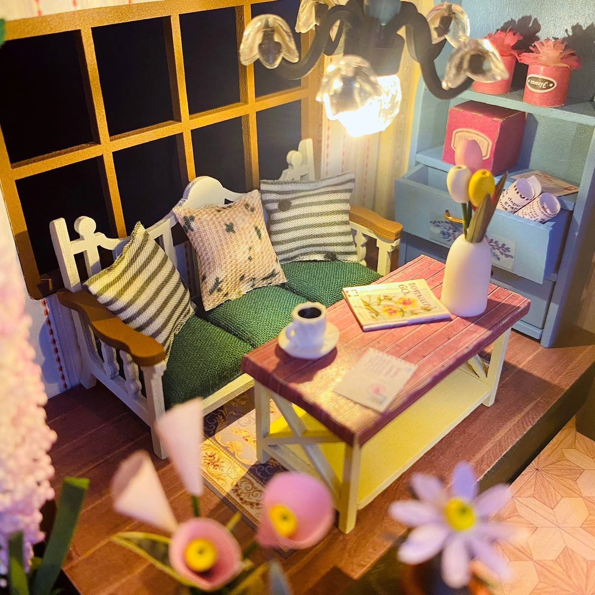 Escape into a peaceful retreat with this miniature kit-a dreamy blend of indoor charm and outdoor beauty. This cozy loft is a plant lover's paradise, filled with blooming flowers, lush greenery, and thoughtful touches of home. With a comfy sofa, a charming desk, and warm light that illuminates the space, it's the perfect hideaway for creativity and relaxation.

2 AAA batteries required; batteries are not included.
Age Range: 14+
Assembled Dimensions: 8.7 x 6.7 x 9.25 inches