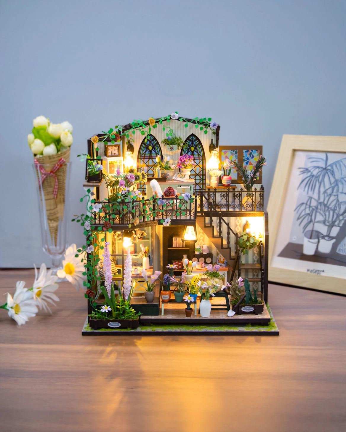 Escape into a peaceful retreat with this miniature kit-a dreamy blend of indoor charm and outdoor beauty. This cozy loft is a plant lover's paradise, filled with blooming flowers, lush greenery, and thoughtful touches of home. With a comfy sofa, a charming desk, and warm light that illuminates the space, it's the perfect hideaway for creativity and relaxation.

2 AAA batteries required; batteries are not included.
Age Range: 14+
Assembled Dimensions: 8.7 x 6.7 x 9.25 inches