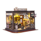 Step into a whimsical world of sugar, spells, and stardust with the Magic Café DIY Miniature House Kit. This enchanting build-it-yourself café brings to life a cozy little corner where witches, wizards, and woodland creatures gather for enchanted brews and magically infused pastries. Watch as tiny shelves fill with jars of mysterious ingredients, and the glass display case glows with cakes that sparkle with edible enchantments.

2 AAA batteries required; batteries are not included.
Ages 14+ 380 pieces
Assem