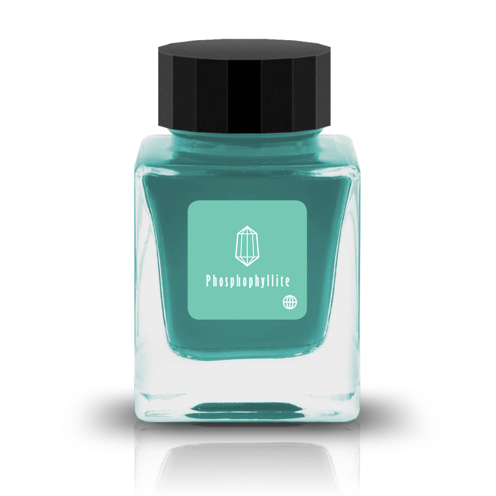 Phosphophyllite, from Tono &amp; Lims’ Earth Contact Series, captures the radiant brilliance of the rare gemstone in ink form. Inspired by birthstones, this shimmering fountain pen ink contains fine glitter particles. Perfect for those who love bold and luminous colors, Phosphophyllite transforms each stroke into a sparkling display of depth and light. Be sure to shake the bottle well before use to evenly disperse the glitter.