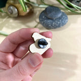Pájaro azul oriental con binoculares en un alfiler de madera 