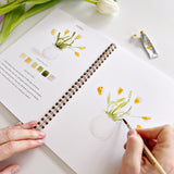 Twelve spring illustrations — a bunny, baby chick, tulips, lilacs, an Easter basket, a bicycle with flowers, and more — each pre-outlined with step-by-step instructions. Paintings take about thirty minutes from start to finish, making it approachable for first-time painters and a favorite for gifting.

Enjoy this peaceful painting hobby on your own, with children, or with friends. Makes a wonderful gift and is perfect for artists of any age.
Details:

12 beginner-friendly illustrations
Thick 120lb watercolo
