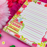 Stay organized in style with this adorable Strawberry Book Stack Notepad! Perfect for jotting down your daily tasks, goals, and bookish ideas, this notepads brings a pop of personality to your desk. Featuring a sturdy cardboard back and premium 70lb. uncoated paper, it's built to last through all your planning adventures.&nbsp;

✦ DETAILS ✦

Size: 4.25" x 5.5"
70 lb. Paper Uncoated

Padded With Cardboard Back

50 Sheets
No magnet backing