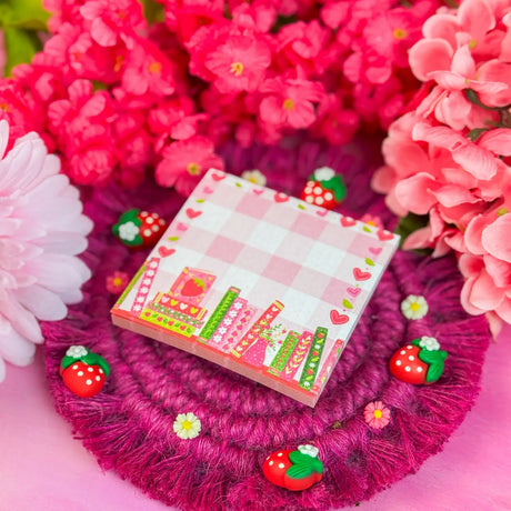 Stay organized in style with this adorable Strawberry Bookshelf Notepad! Perfect for jotting down your daily tasks, goals, and bookish ideas, this notepads brings a pop of personality to your desk. Featuring a sturdy cardboard back and premium 70lb. uncoated paper, it's built to last through all your planning adventures.&nbsp;

✦ DETAILS ✦

Size: 3" x 3"
70 lb. Paper Uncoated

Padded With Cardboard Back

50 Sheets
No magnet backing