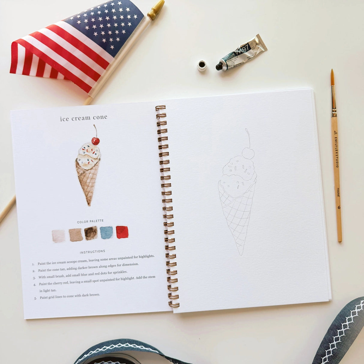 Twelve illustrations of flags, stars, and classic summer scenes — each pre-outlined with step-by-step instructions. Paintings take about thirty minutes from start to finish, making it approachable for first-time painters and a favorite for gifting.

A timely release for America's 250th anniversary in 2026. A strong May–July seller and a natural fit for home, gift, and patriotic-themed boutiques.

12 beginner-friendly illustrations
Thick 120lb watercolor paper&nbsp;
Lay-flat pages with spiral binding for has