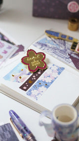 Esterbrook x Sakuradragon Washi Tape - Sky

The Sky Washi Tape turns Cindy Duong's Sakura Street Sky illustration into a continuous scene. Soft clouds and rooftops fill the 3.5 cm-wide tape, with gold foil details appearing throughout the design. Each roll contains five meters for decorating journals, letters, and stationery projects.&nbsp;
