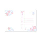 Send a note from Sakura Street with this set of three premium postcards featuring Cindy Duong's original illustrations. The set includes the Dino Sky, Dino Sakura, and Sakura Street designs, each printed on heavyweight cardstock. A custom address layout on the reverse adds more of the collection's playful artwork to every piece of correspondence.