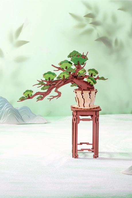 This intricately designed puzzle invites you to assemble a lush, detailed bonsai tree, capturing the essence of a peaceful, natural landscape. Each precision-cut wooden piece comes together effortlessly, allowing you to create a miniature masterpiece that symbolizes strength, resilience, and tranquility. Whether you're a puzzle lover, a fan of bonsai trees, or looking for a unique gift, this evergreen pine bonsai tree makes for a perfect addition to any collection.

With no glue or special tools required, t