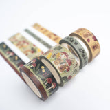 Set of decorative tape rolls with nature-themed designs on a white background. Add a dash of whimsy to your creative space with the Field Mouse Washi Tape Set. Featuring soft florals, cozy textures, and tiny mouse illustrations, this charming set brings a sweet woodland story to life across four unique rolls