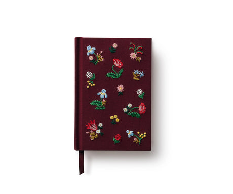 A mini hardcover journal, embroidered with delicate Gracie blooms and gold accents. Inside, find 240 blank, unlined pages and a ribbon bookmark.